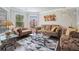 Cozy living room with bay windows and hardwood floors, adorned with designer furniture and decor at 3399 In Bloom Way, Auburn, GA 30011