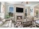 Comfortable living room featuring a fireplace, stylish decor, and bright, airy atmosphere at 3399 In Bloom Way, Auburn, GA 30011
