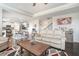 Open-concept living area with a view of the dining and kitchen area, and plenty of natural light at 3399 In Bloom Way, Auburn, GA 30011