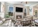 Living room with fireplace and comfortable furniture, complemented by natural light from large windows at 3399 In Bloom Way, Auburn, GA 30011