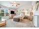 Light filled primary bedroom featuring carpeted floors, a ceiling fan and a large window at 3399 In Bloom Way, Auburn, GA 30011