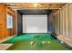 Unfinished basement area featuring golf simulator at 1606 Chancery Ln, Lithia Springs, GA 30122
