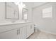 Bright bathroom featuring dual sinks, tile floors, and ample counter space at 1606 Chancery Ln, Lithia Springs, GA 30122