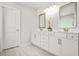Bathroom with double sinks, cabinetry, and tile flooring at 1606 Chancery Ln, Lithia Springs, GA 30122