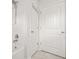 Well-lit bathroom featuring tile floors, shower, and doors at 1606 Chancery Ln, Lithia Springs, GA 30122