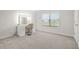 Well-lit bedroom featuring gray carpet floors, a window, and makeup vanity at 1606 Chancery Ln, Lithia Springs, GA 30122