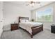 Cozy bedroom with a ceiling fan, plush carpet, and ample natural light from the window at 1606 Chancery Ln, Lithia Springs, GA 30122