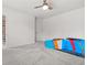 Bright bedroom featuring carpet floors, ceiling fan, and race car bed at 1606 Chancery Ln, Lithia Springs, GA 30122