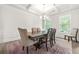 Elegant dining room featuring a stylish chandelier, large table with seating, and wainscoting details at 1606 Chancery Ln, Lithia Springs, GA 30122