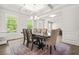 Elegant dining room featuring wainscotting, a decorative chandelier, and large windows at 1606 Chancery Ln, Lithia Springs, GA 30122