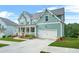 Beautiful two-story home with a front porch, lush green lawn, and driveway leading to the two-car garage at 1606 Chancery Ln, Lithia Springs, GA 30122