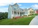 Charming two-story home featuring a wide porch, manicured lawn, and colorful flower beds at 1606 Chancery Ln, Lithia Springs, GA 30122