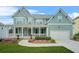 Inviting two-story home with a large front porch, attached garage, and well-maintained landscaping at 1606 Chancery Ln, Lithia Springs, GA 30122