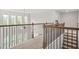Hallway overlooking the large windows in the living room downstairs at 1606 Chancery Ln, Lithia Springs, GA 30122
