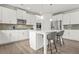 Bright kitchen with modern appliances, white cabinets, an island with bar stool seating at 1606 Chancery Ln, Lithia Springs, GA 30122