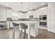 Modern kitchen with white cabinetry, a center island, stainless steel appliances, and stylish pendant lighting at 1606 Chancery Ln, Lithia Springs, GA 30122