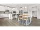 Kitchen and dining area combo offers a modern island, ample cabinetry, and a cozy bench dining set at 1606 Chancery Ln, Lithia Springs, GA 30122