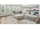 Bright living room with a large sectional sofa, plush rug, and plenty of natural light from large windows at 1606 Chancery Ln, Lithia Springs, GA 30122