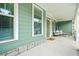 Cozy covered porch with stone accents, comfortable seating, and a welcoming entrance at 1606 Chancery Ln, Lithia Springs, GA 30122