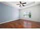 Spacious bedroom features hardwood floors, a ceiling fan, and a large window with natural light at 2061 Grove Field Lane #13, Marietta, GA 30064