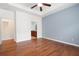 Bedroom featuring hardwood floors, light blue accent wall, and an ensuite bathroom at 2061 Grove Field Lane #13, Marietta, GA 30064