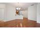 Dining room featuring hardwood floors, decorative trim, and modern chandelier open to kitchen at 2061 Grove Field Lane #13, Marietta, GA 30064