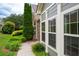 Home exterior with gray siding, stone accents, white trim, and well-maintained landscaping at 2061 Grove Field Lane #13, Marietta, GA 30064