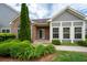 Charming home featuring stone accents, lush landscaping, and a welcoming entrance at 2061 Grove Field Lane #13, Marietta, GA 30064