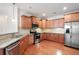 Kitchen featuring stainless steel appliances, granite countertops, hardwood floors, and wood cabinetry at 2061 Grove Field Lane #13, Marietta, GA 30064