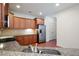 Kitchen featuring stainless steel appliances, granite countertops, and rich wood cabinets at 2061 Grove Field Lane #13, Marietta, GA 30064