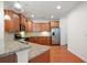 Kitchen featuring stainless steel appliances, granite countertops, wood cabinets and hardwood floors at 2061 Grove Field Lane #13, Marietta, GA 30064