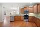 Kitchen featuring stainless steel appliances, granite countertops, and hardwood floors with eat in nook at 2061 Grove Field Lane #13, Marietta, GA 30064