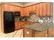 Well-lit kitchen featuring ample cabinetry, countertops, and a modern black refrigerator at 2061 Grove Field Lane #13, Marietta, GA 30064