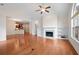 Bright living room with a ceiling fan, fireplace with built-in shelving, and shiny hardwood floors at 2061 Grove Field Lane #13, Marietta, GA 30064