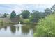 Scenic pond view with a fountain, surrounded by lush trees and landscaping at 2061 Grove Field Lane #13, Marietta, GA 30064