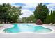 Community pool area featuring a unique shape, in-pool spa, landscaping, and lounge chairs at 2061 Grove Field Lane #13, Marietta, GA 30064