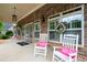 Inviting porch with stone accents, rocking chairs, welcome mats, and decorative wreaths at 2061 Grove Field Lane #13, Marietta, GA 30064