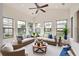 Inviting sunroom with ceiling fan, comfortable seating, and large windows overlooking the yard at 2061 Grove Field Lane #13, Marietta, GA 30064