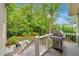 Back deck with grill, overlooking a beautifully landscaped yard at 3925 Sheldon Ne Dr, Atlanta, GA 30342