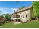 Lush backyard with screened porch, open deck, stone patio, and well-maintained landscaping at 3925 Sheldon Ne Dr, Atlanta, GA 30342