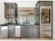 Stylish bar area featuring dark cabinetry, a wine fridge, ample storage, and a decorative backsplash at 3925 Sheldon Ne Dr, Atlanta, GA 30342