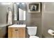 Modern powder room features a wood vanity with a gray painted wall, modern mirror and lighting at 3925 Sheldon Ne Dr, Atlanta, GA 30342