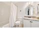 Bathroom featuring a white subway tile shower, white toilet, and vanity with granite countertop at 3925 Sheldon Ne Dr, Atlanta, GA 30342