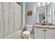 Cozy bathroom with a bathtub, toilet, and a granite-topped vanity with a mirror at 3925 Sheldon Ne Dr, Atlanta, GA 30342
