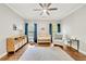 Bright Bedroom with a crib, area rug, dresser, rocker, and a ceiling fan for a soothing atmosphere at 3925 Sheldon Ne Dr, Atlanta, GA 30342