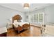 Comfortable bedroom with hardwood floors, a wooden bed frame, a window, and neutral decor at 3925 Sheldon Ne Dr, Atlanta, GA 30342