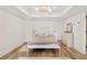 Bright bedroom features hardwood floors, white trim, recessed lights and light-colored walls and modern furnishings at 3925 Sheldon Ne Dr, Atlanta, GA 30342