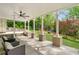 Covered patio with stone columns, ceiling fan, and outdoor seating overlooking the yard at 3925 Sheldon Ne Dr, Atlanta, GA 30342