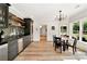 Charming dining area features elegant chandelier, wet bar, and lovely backyard views through large windows at 3925 Sheldon Ne Dr, Atlanta, GA 30342