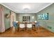 Stylish dining room featuring elegant wall decor, a modern chandelier, and hardwood floors at 3925 Sheldon Ne Dr, Atlanta, GA 30342